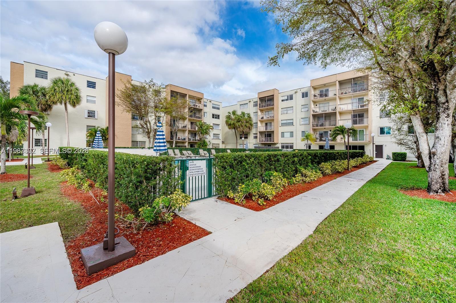 14250 Southwest 62nd Street, Unit 517 Miami, FL 33183 - Photo 40 of 47 a front view of a house with garden