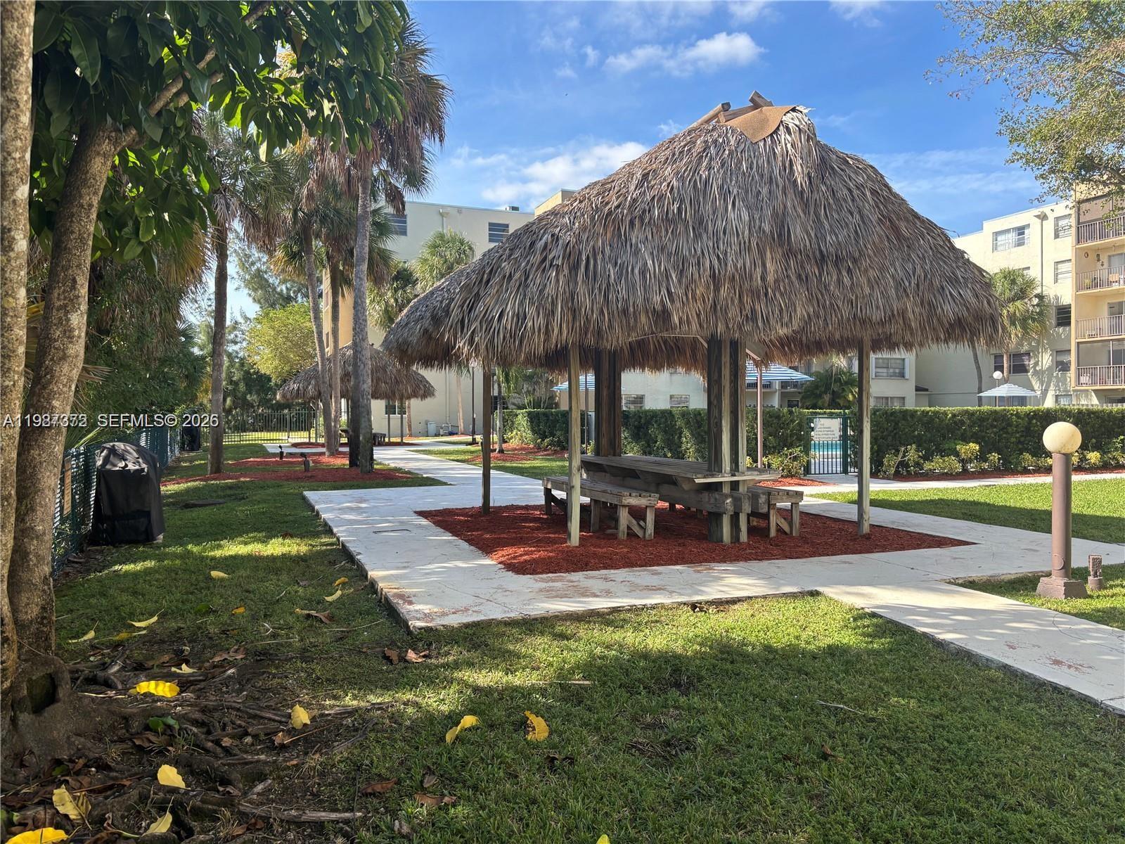 14250 Southwest 62nd Street, Unit 517 Miami, FL 33183 - Photo 41 of 47 a view of outdoor space yard deck patio and outdoor kitchen