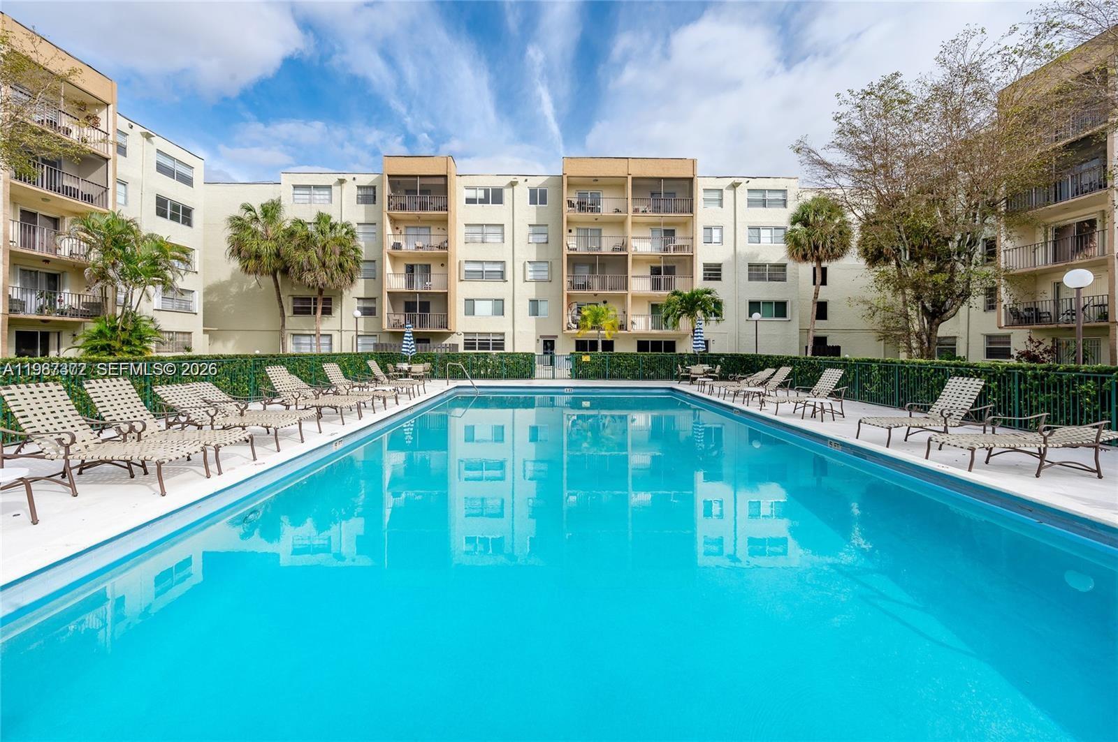 14250 Southwest 62nd Street, Unit 517 Miami, FL 33183 - Photo 45 of 47 a swimming pool with outdoor seating and yard