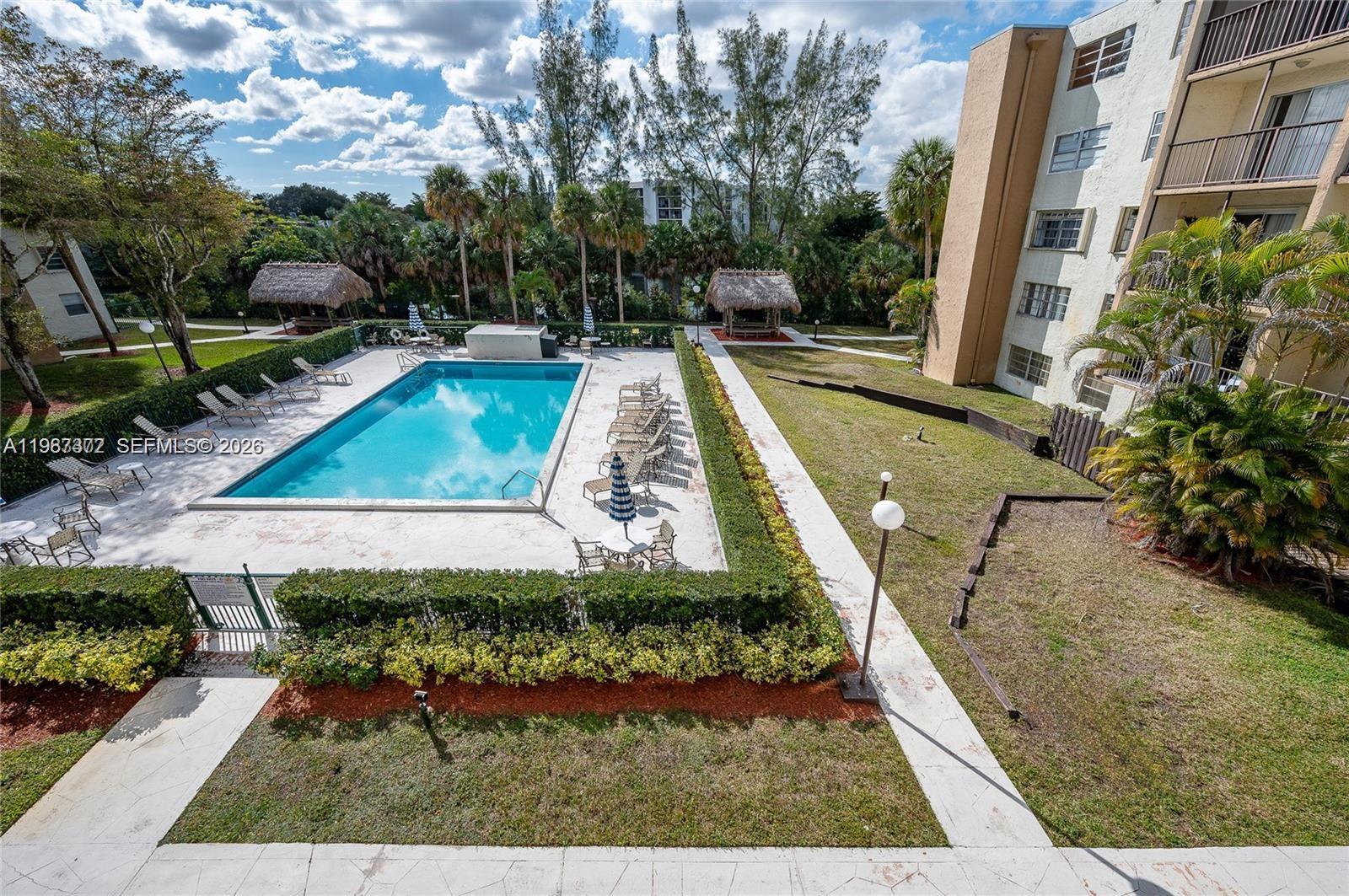 14250 Southwest 62nd Street, Unit 517 Miami, FL 33183 - Photo 46 of 47 a view of a swimming pool with sitting area