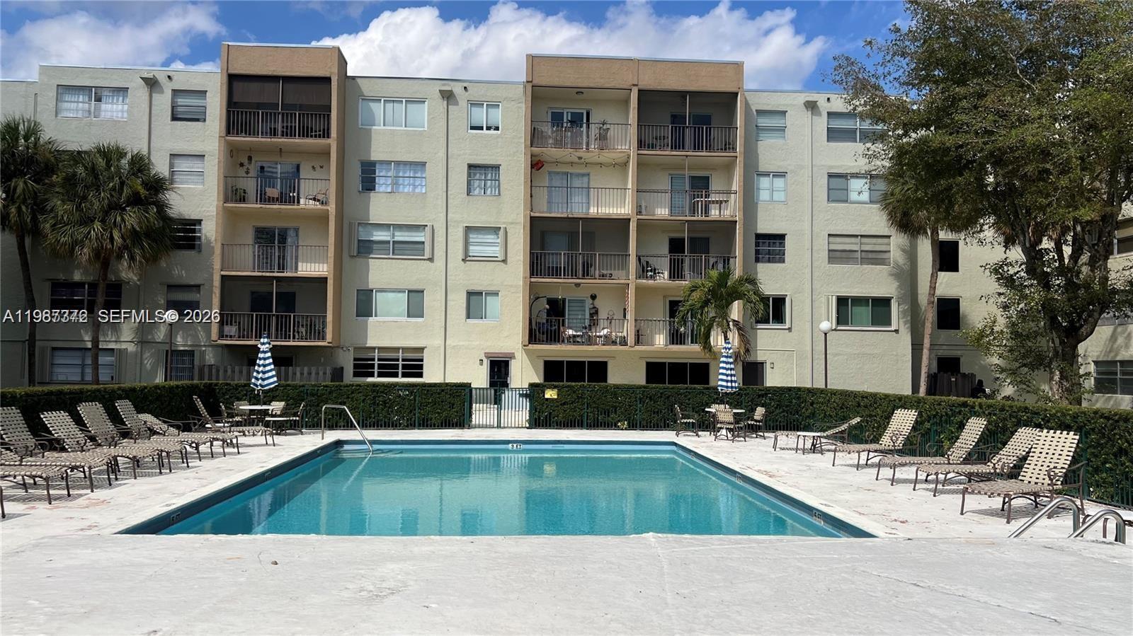 14250 Southwest 62nd Street, Unit 517 Miami, FL 33183 - Photo 47 of 47 a view of pool with outdoor seating