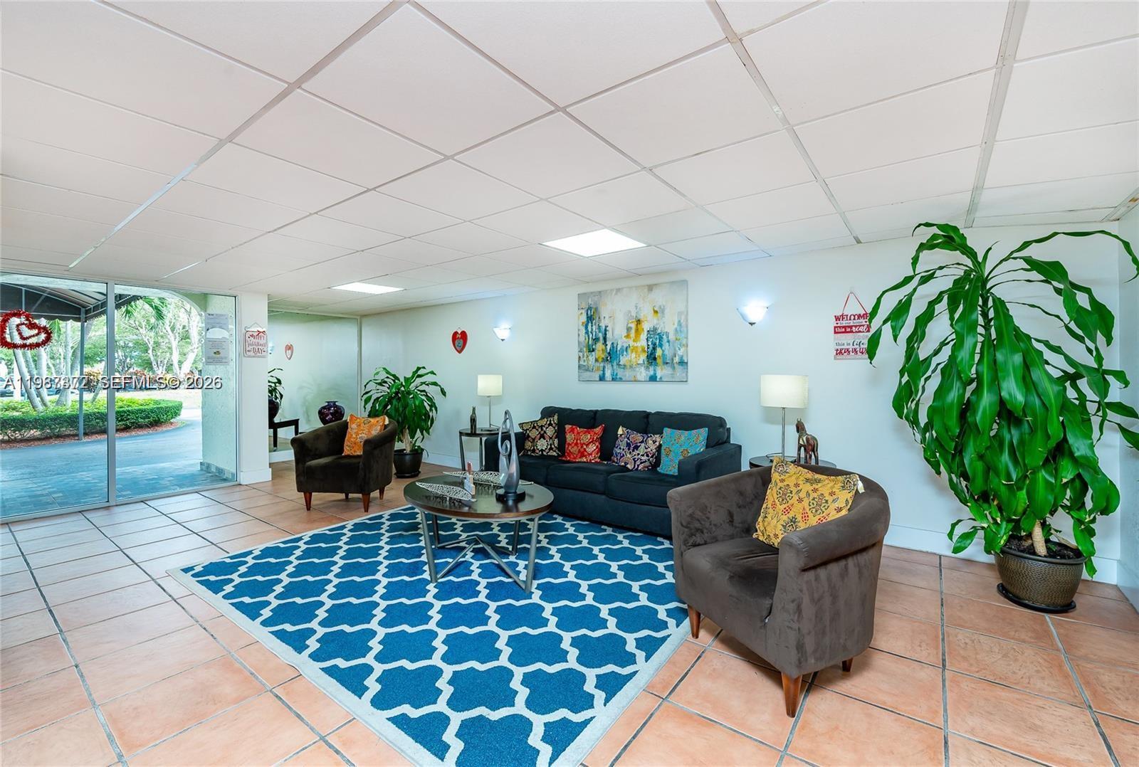 14250 Southwest 62nd Street, Unit 517 Miami, FL 33183 - Photo 6 of 47 a living room with patio furniture and a potted plant