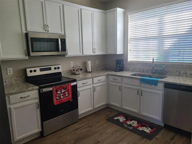 a kitchen with a sink cabinets and window