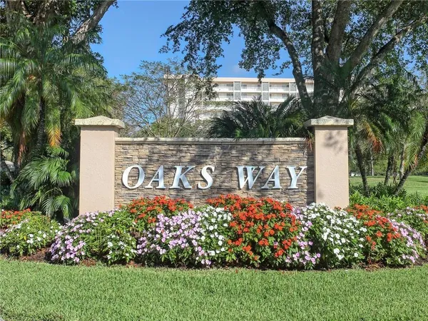 a view of sign board with flower around
