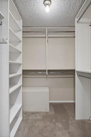a kitchen with granite countertop a refrigerator stove sink and cabinets