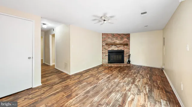 a view of an empty room and wooden floor