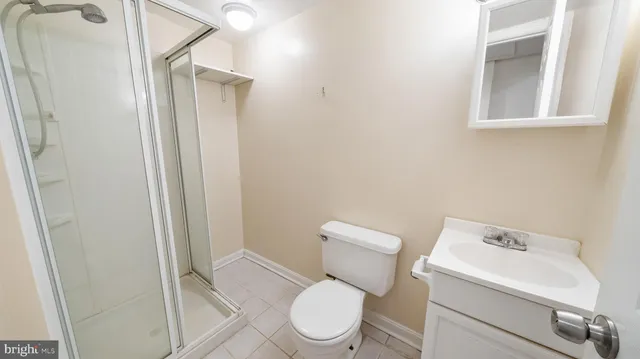 a white toilet sitting next to a bathroom sink