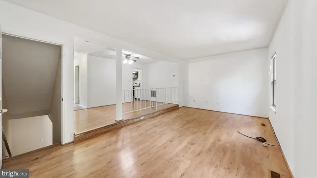 a view of empty room with wooden floor