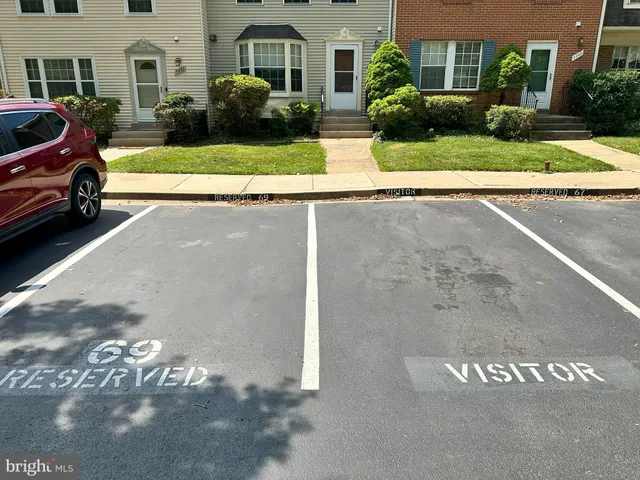 a view of a white house with a yard