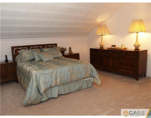 21 Phillips Road Edison, NJ 08817 - Photo 7 of 10 a bedroom with a bed and a lamp