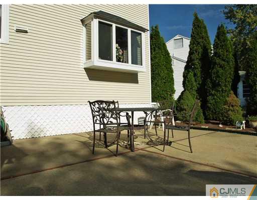 21 Phillips Road Edison, NJ 08817 - Photo 9 of 10 a view of a patio with table and chairs and potted plants
