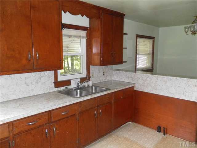 3032 Ross Road Durham, NC 27703 - Photo 7 of 11 a kitchen with a sink a window and cabinets