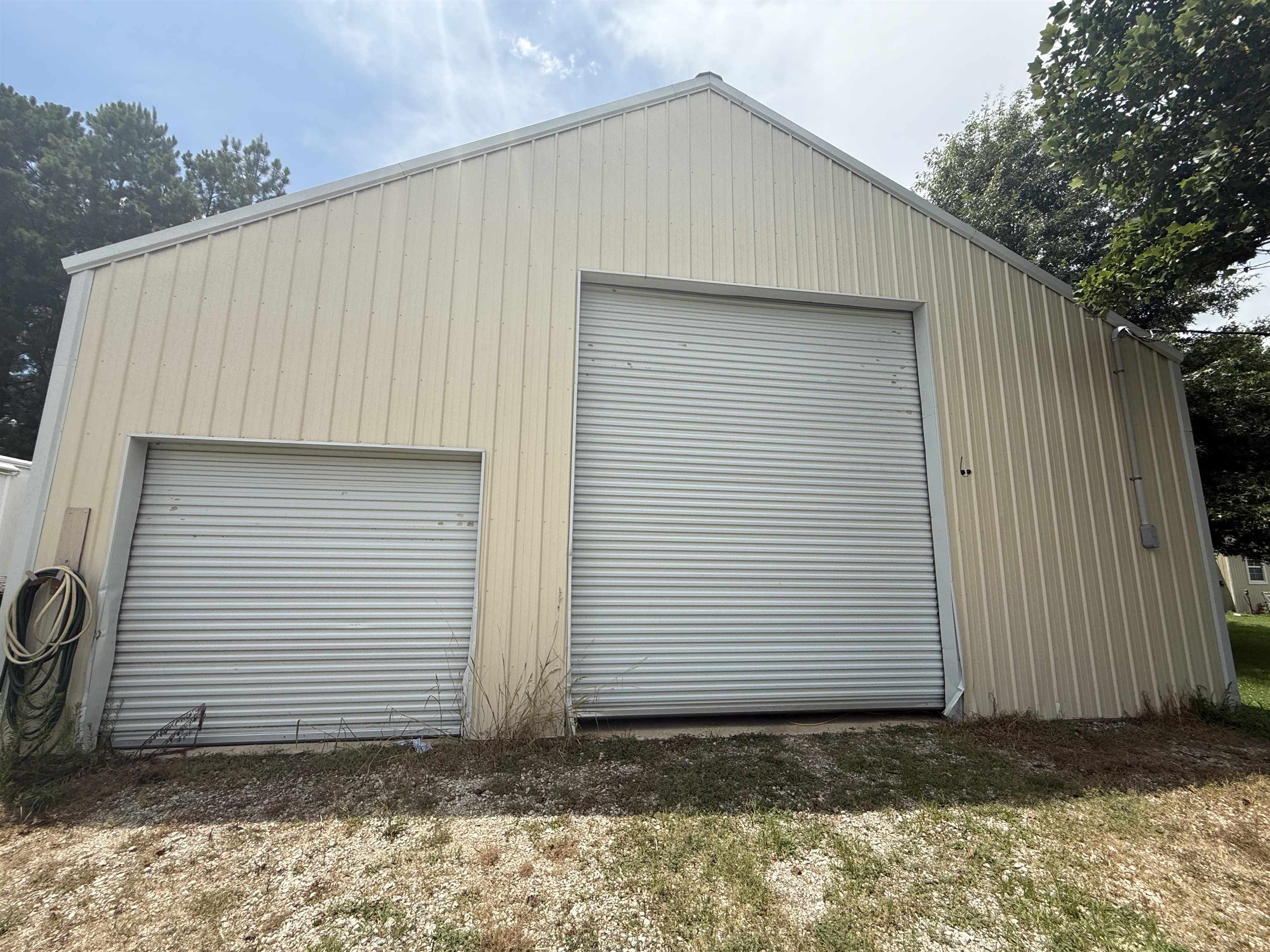 2201 Robert Johnson Road Covington, TN 38019 - Photo 8 of 25 Metal-sided building featuring a gabled roofline and two roll-up doors