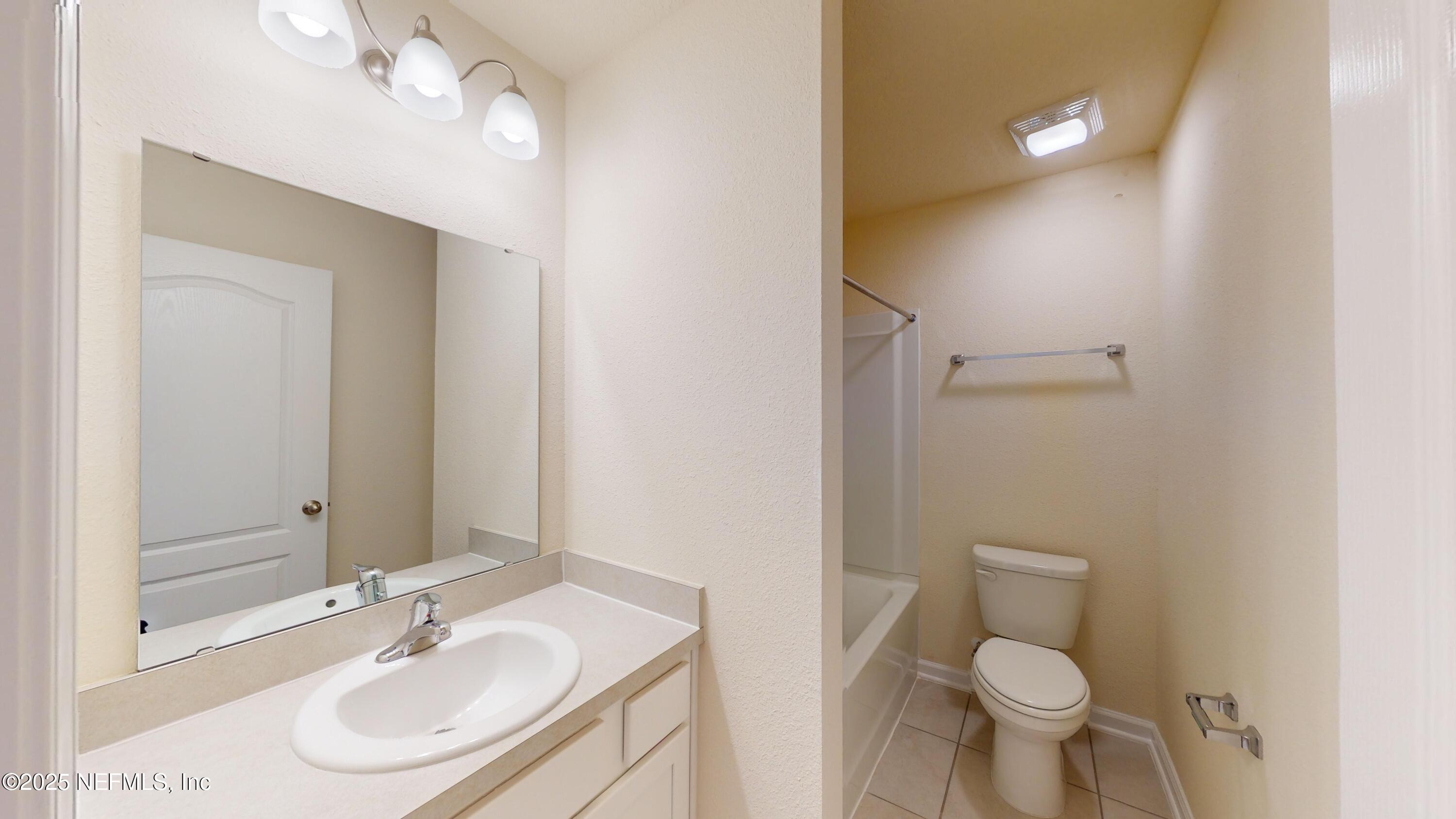 67 Oarsman Xing Drive St. Augustine, FL 32095 - Photo 15 of 33 a bathroom with a sink toilet vanity and shower