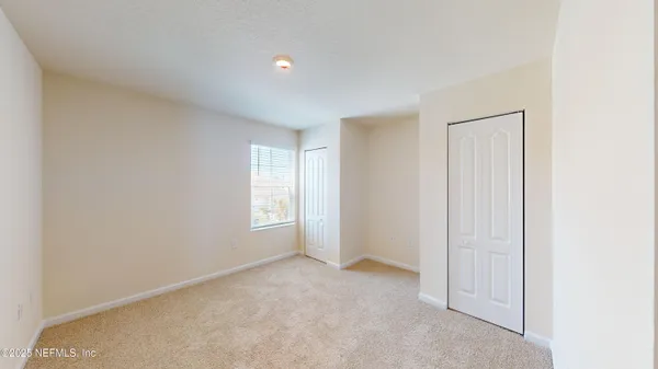 a view of an empty room and a window