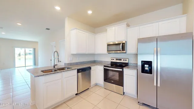 a kitchen with a sink appliances and cabinets