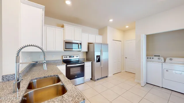 a kitchen with stainless steel appliances granite countertop a sink and cabinets