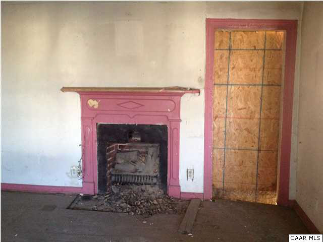 776 Ridge Street Charlottesville, VA 22902 - Photo 3 of 7 Fireplace and boarded up former doorway to kitchen