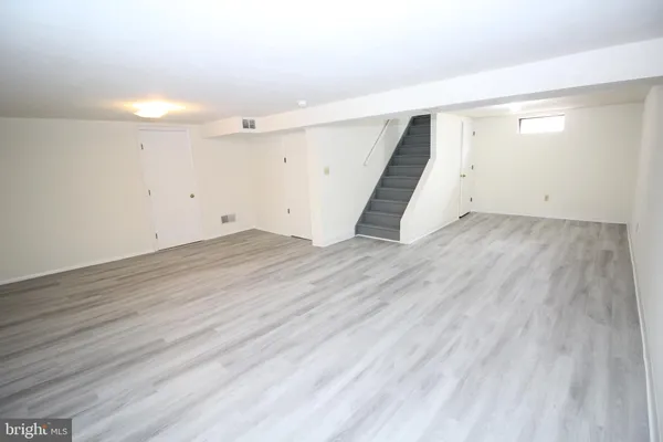 an empty room with wooden floor