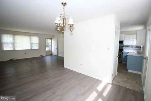 a view of a kitchen with a sink and dishwasher wooden floor