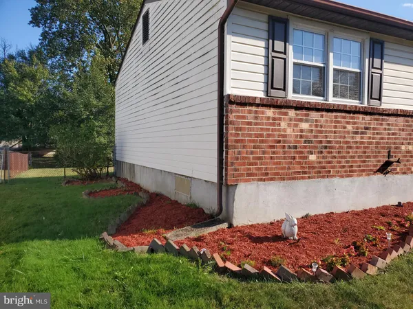 a view of backyard with plants and outdoor seating