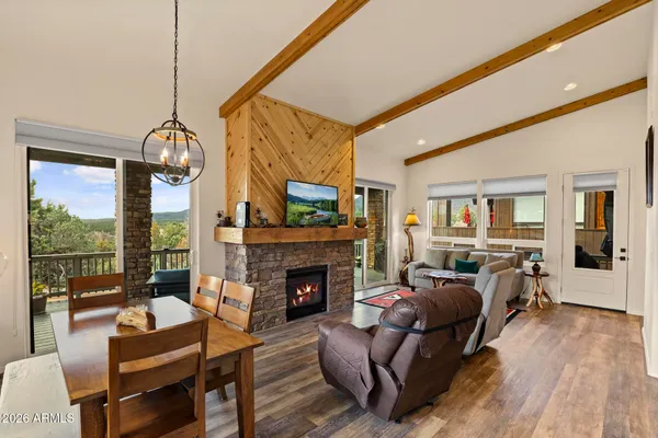 a living room with furniture a fireplace and a floor to ceiling window