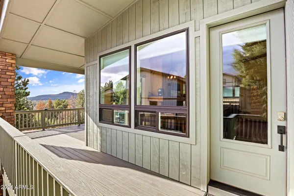 a view of a balcony with floor to ceiling window with wooden floor