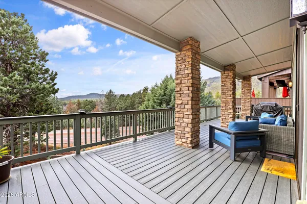 a view of balcony with wooden floor and outdoor seating