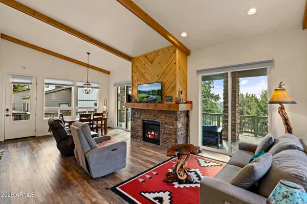 a living room with furniture fireplace and a large window