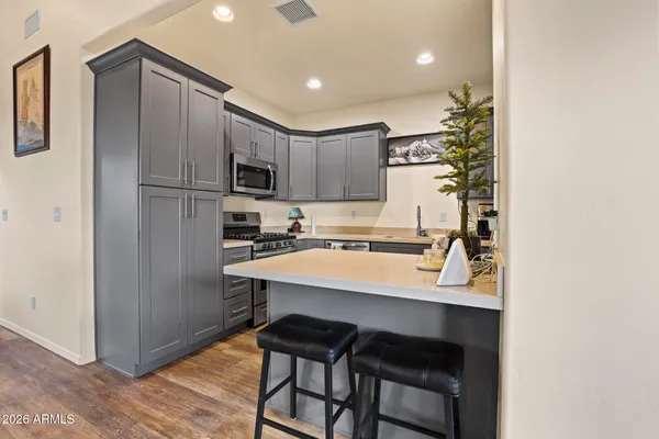 a kitchen with kitchen island a sink appliances and cabinets