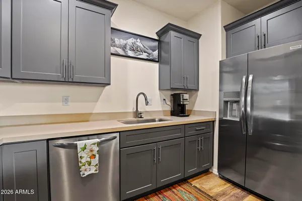 a kitchen with stainless steel appliances granite countertop a refrigerator and a sink