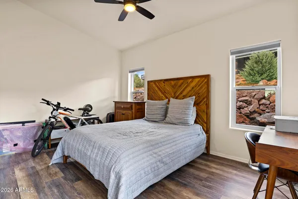 a bedroom with a bed and wooden floor