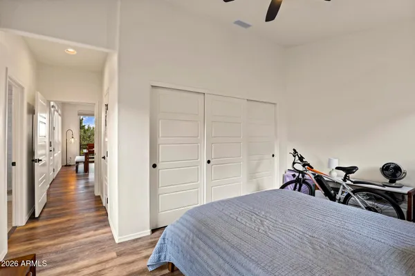 a bedroom with a bed and wooden floor