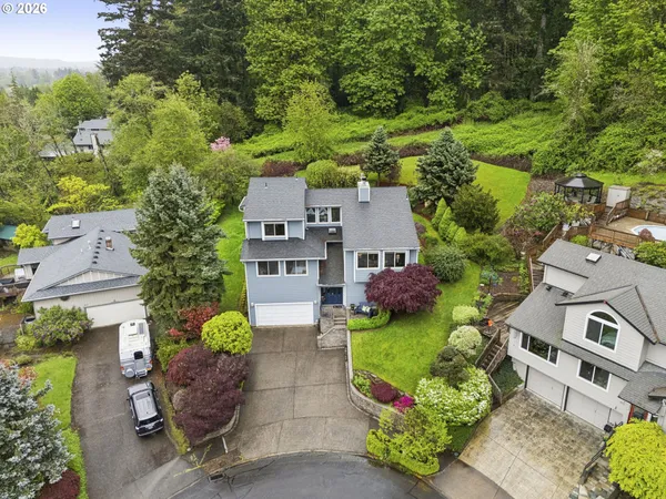 an aerial view of a house with garden space and street view