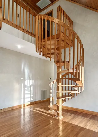a view of empty room with wooden floor and fireplace