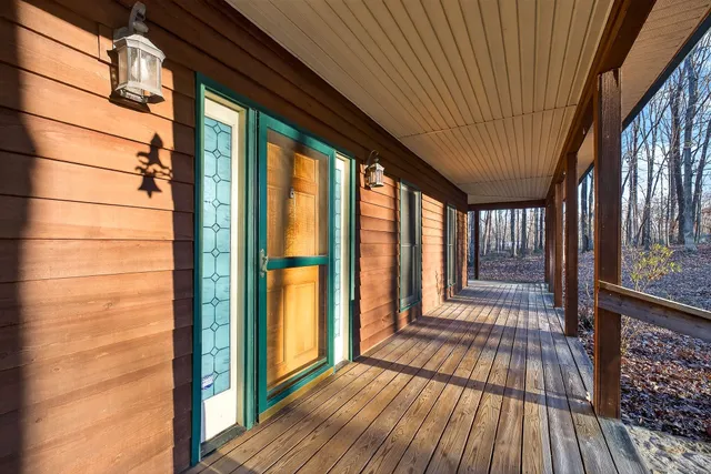 a view of empty room with wooden floor and fireplace