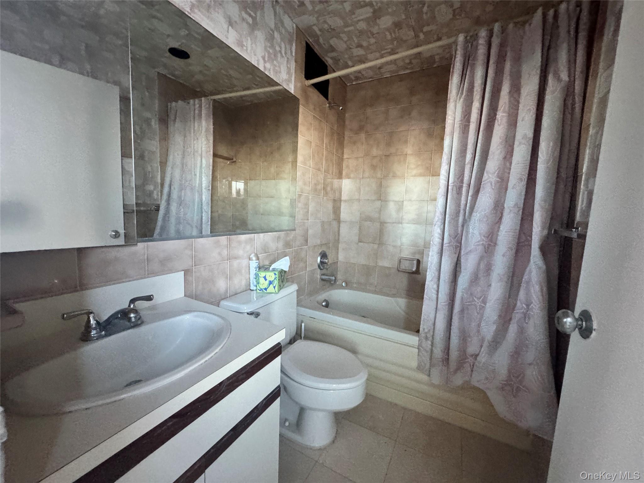 360 Shore Road, Unit 8L Long Beach, NY 11561 - Photo 16 of 21 a bathroom with a sink toilet tub and shower