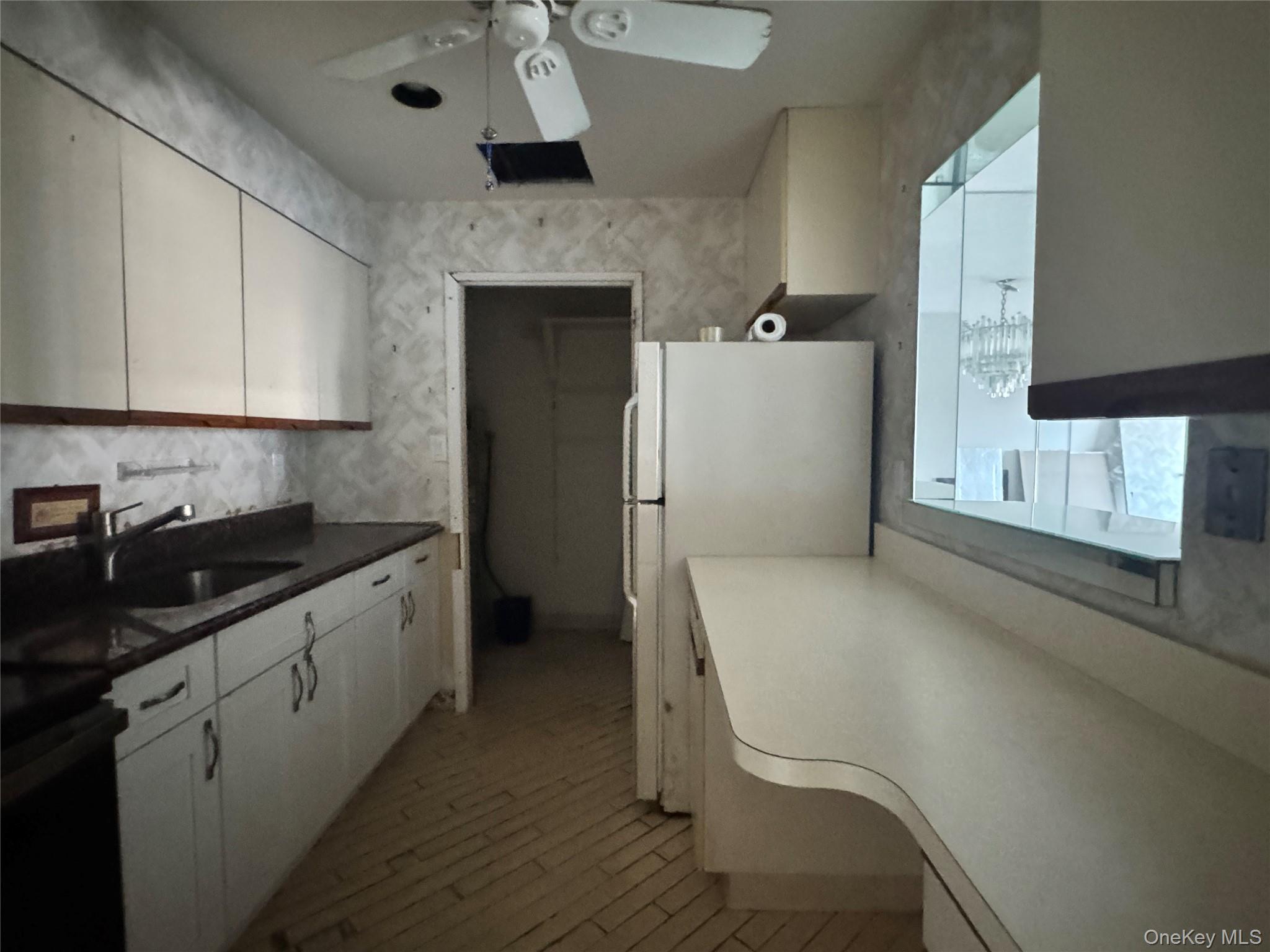 360 Shore Road, Unit 8L Long Beach, NY 11561 - Photo 19 of 21 a kitchen with a refrigerator and a sink
