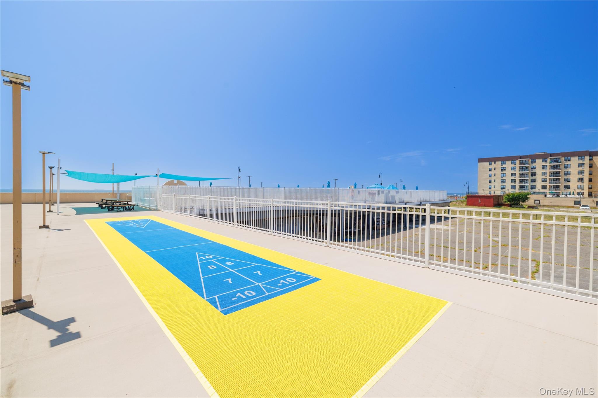 360 Shore Road, Unit 8L Long Beach, NY 11561 - Photo 5 of 12 a view of a swimming pool with a lounge chair