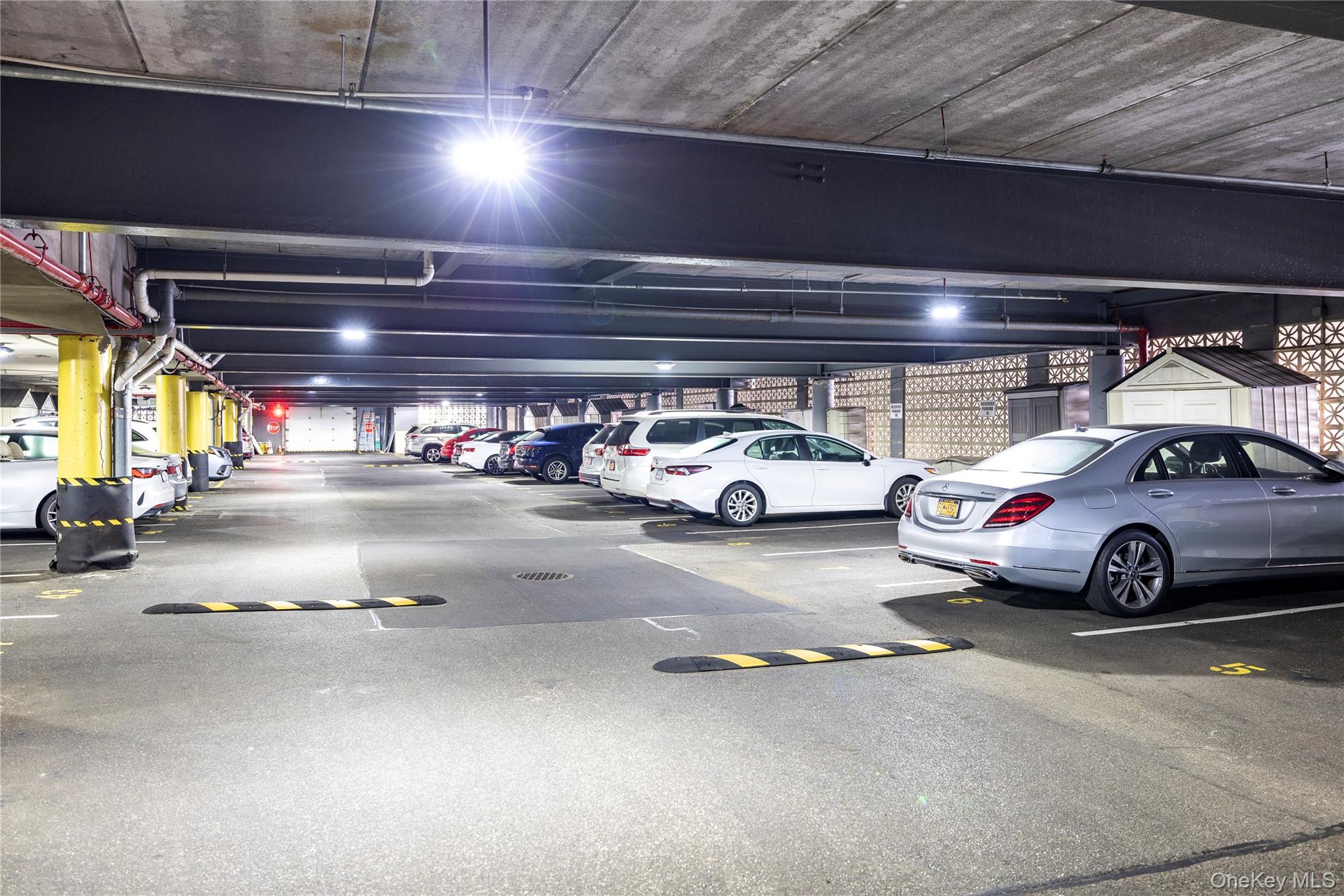 360 Shore Road, Unit 8L Long Beach, NY 11561 - Photo 6 of 12 a view of parking garage with cars