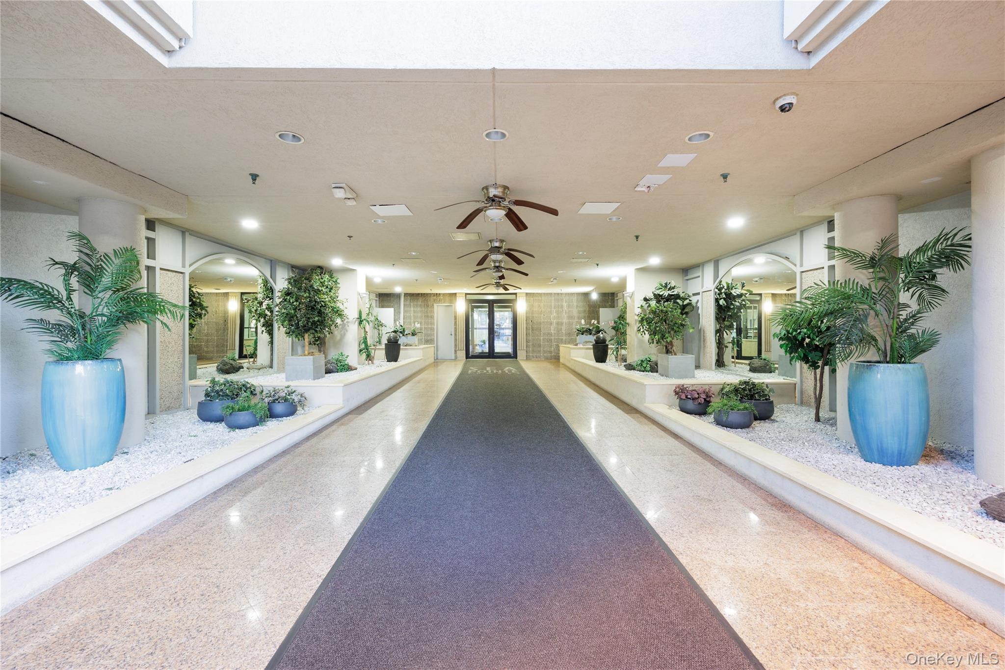 360 Shore Road, Unit 8L Long Beach, NY 11561 - Photo 10 of 12 a view of a lobby with potted plants