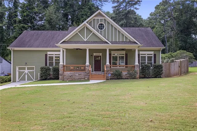 a front view of a house with a garden