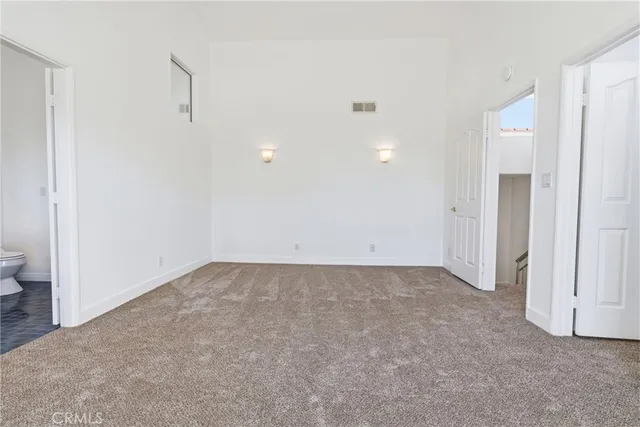 a view of a room with an empty space and a window