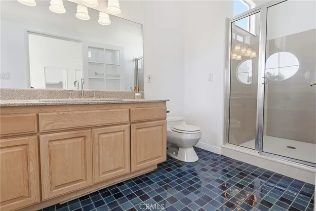 a spacious bathroom with a toilet a sink and mirror