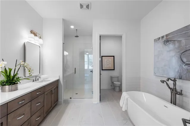 a spacious bathroom with a double vanity sink mirror double and shower