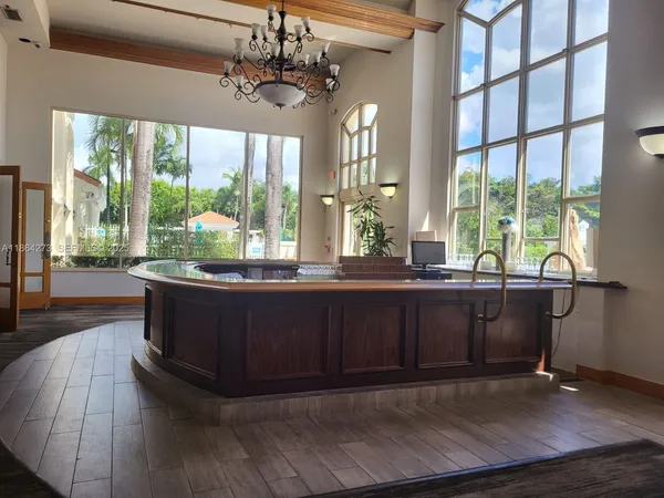 a kitchen with stainless steel appliances white cabinets and a stove a refrigerator with wooden floors