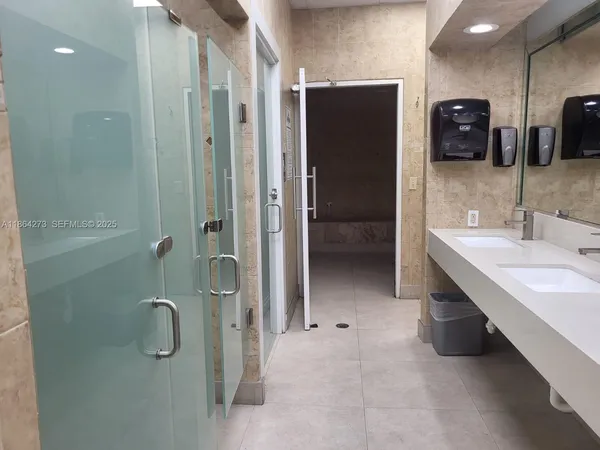 a bathroom with a shower a toilet and sink