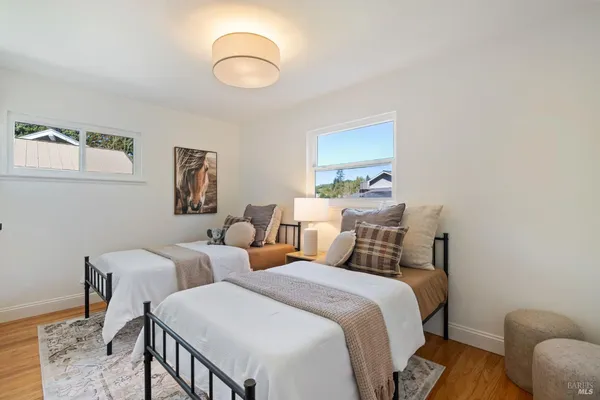 a bedroom with two beds and a chandelier