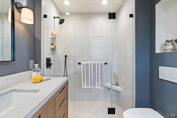 a bathroom with a sink toilet and shower