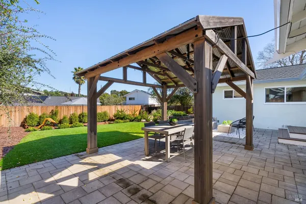 a patio with a yard table and chairs